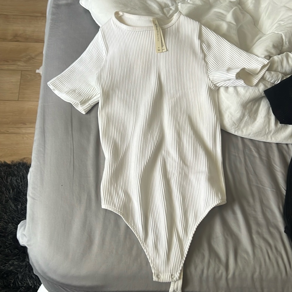 The group Babaton aritzia bodysuit